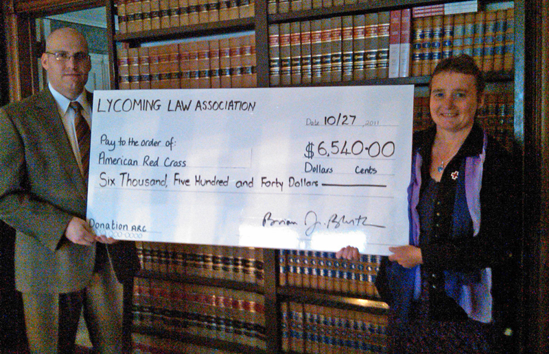 Brian Bluth presenting a check to Valerie Whyman, with the American Red Cross.